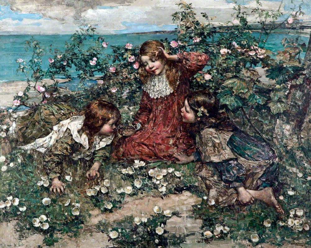 3 little girls in a garden. Playing in a flower bush with the sea in the background.