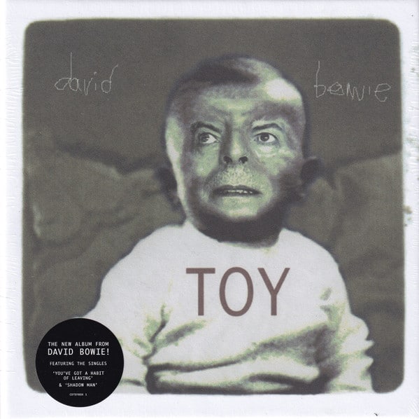 Part of Worst Record Covers. David Bowie's face superimposed onto a baby's bald head, he's wearing a white top which reads TOY.