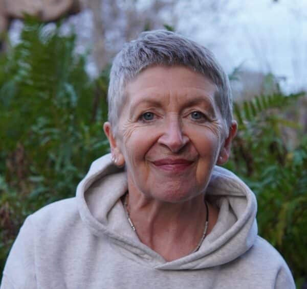 A portrait photograph of yoga instructor Claire Hesketh wearing a grey hoodie